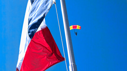 Sky Diver Hides Behind The Flag
